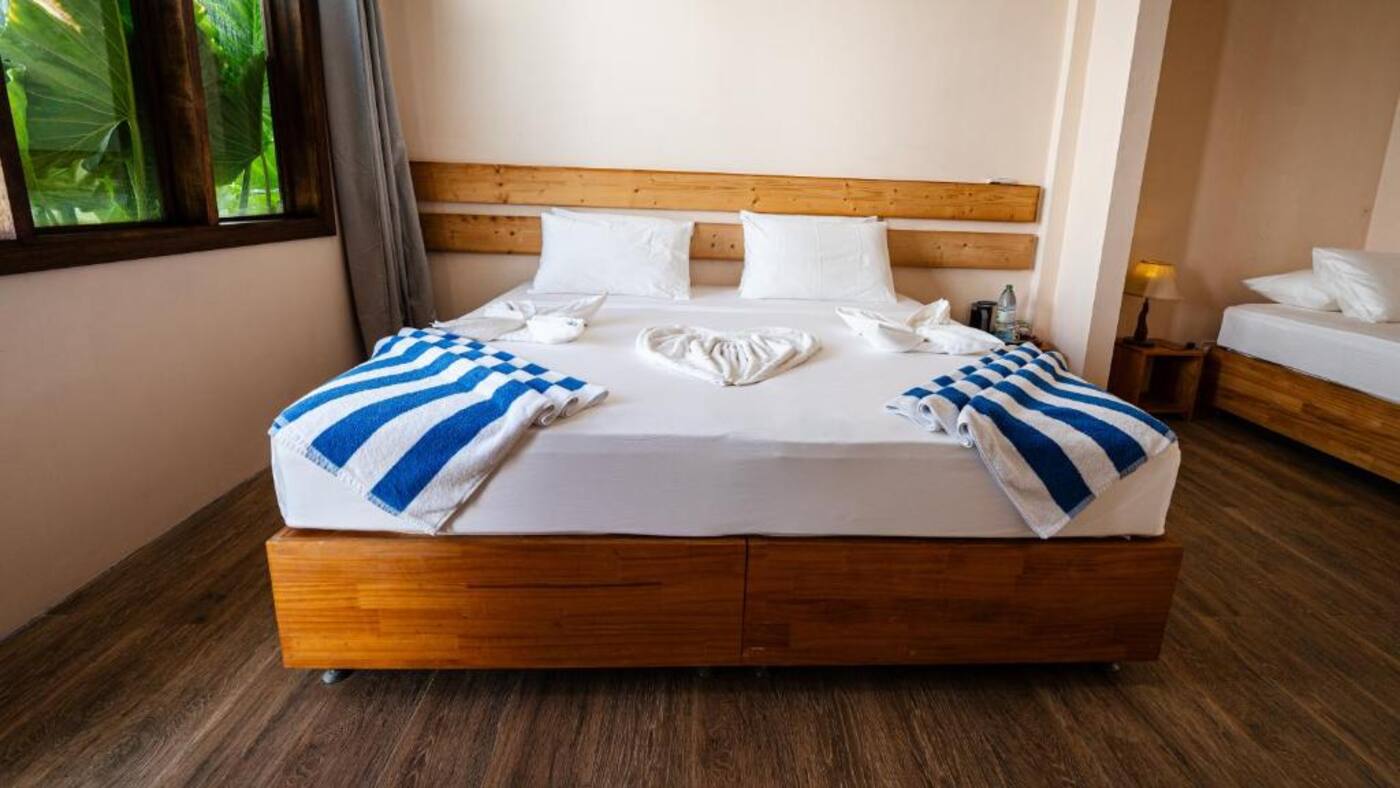 Bright room with a large bed and garden window